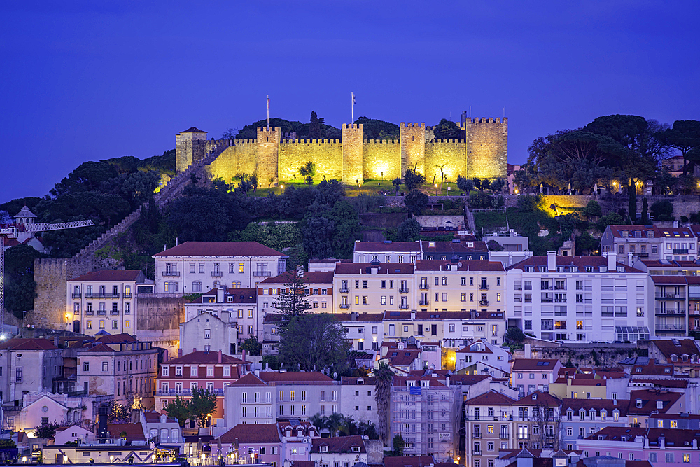 View of Lisbon Castle from Miradouro de Sao Pedro de Alcantara at dusk, Lisbon, Portugal, Europe