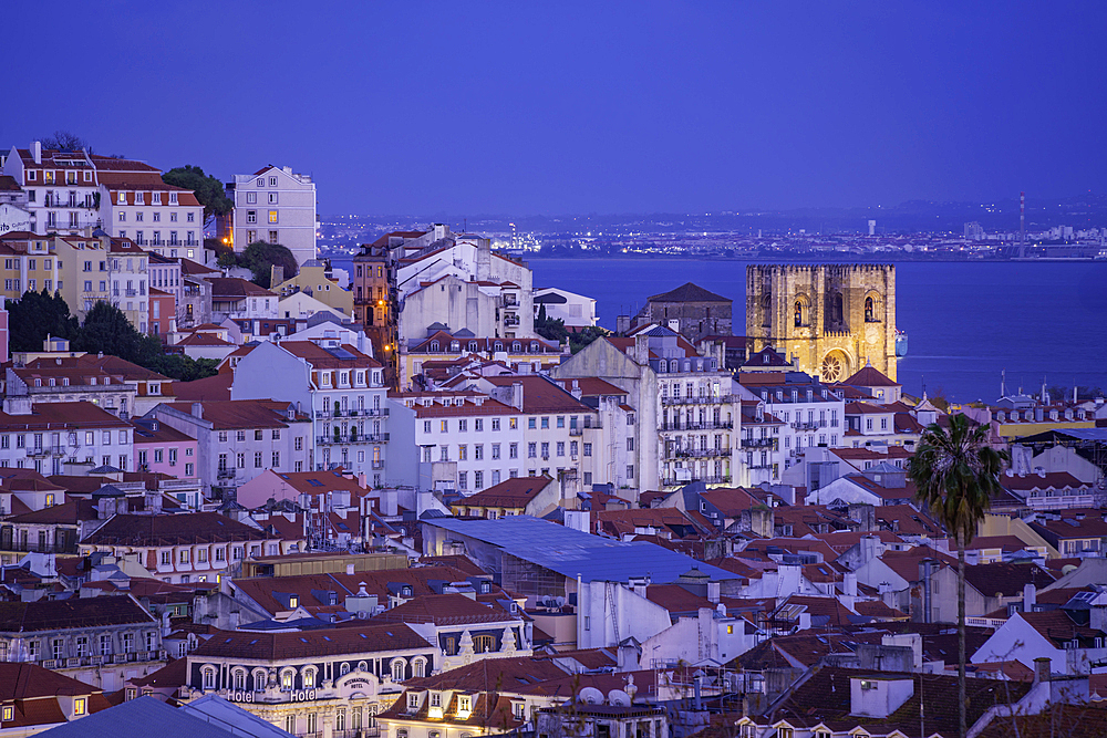 View of Lisbon and fountain in Miradouro de Sao Pedro de Alcantara at dusk, Lisbon, Portugal, Europe