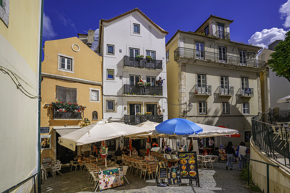 View of colourful buildings and cafe in the Alfama District on a sunny day, Lisbon, Portugal, Europe