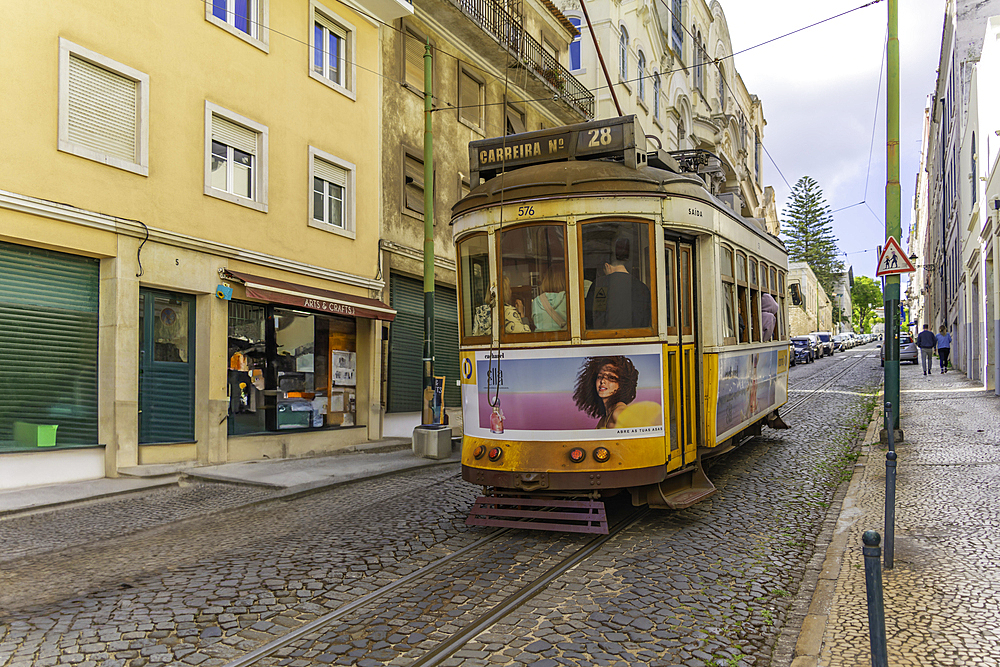 View of vintage yellow No28 tram on a sunny day in the Alfama District, Lisbon, Portugal, Europe