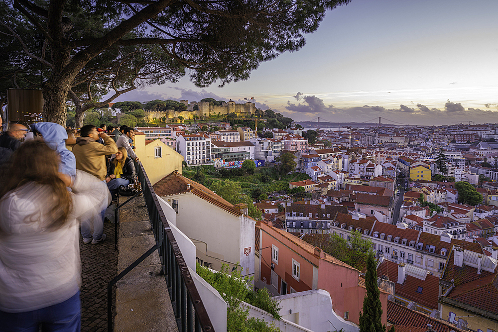 Panoramic view of Lisbon Castle from Miradouro da Senhora do Monte scenic point at dusk in the Alfama District, Lisbon, Portugal, Europe