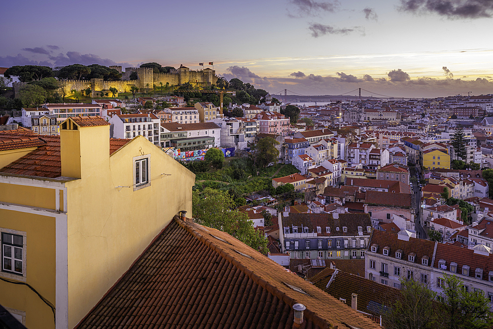 Panoramic view of Lisbon Castle from Miradouro da Senhora do Monte scenic point at dusk in the Alfama District, Lisbon, Portugal, Europe