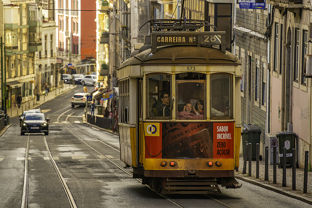View of vintage tram and colourful buildings in the Alfama District on a sunny day, Lisbon, Portugal, Europe