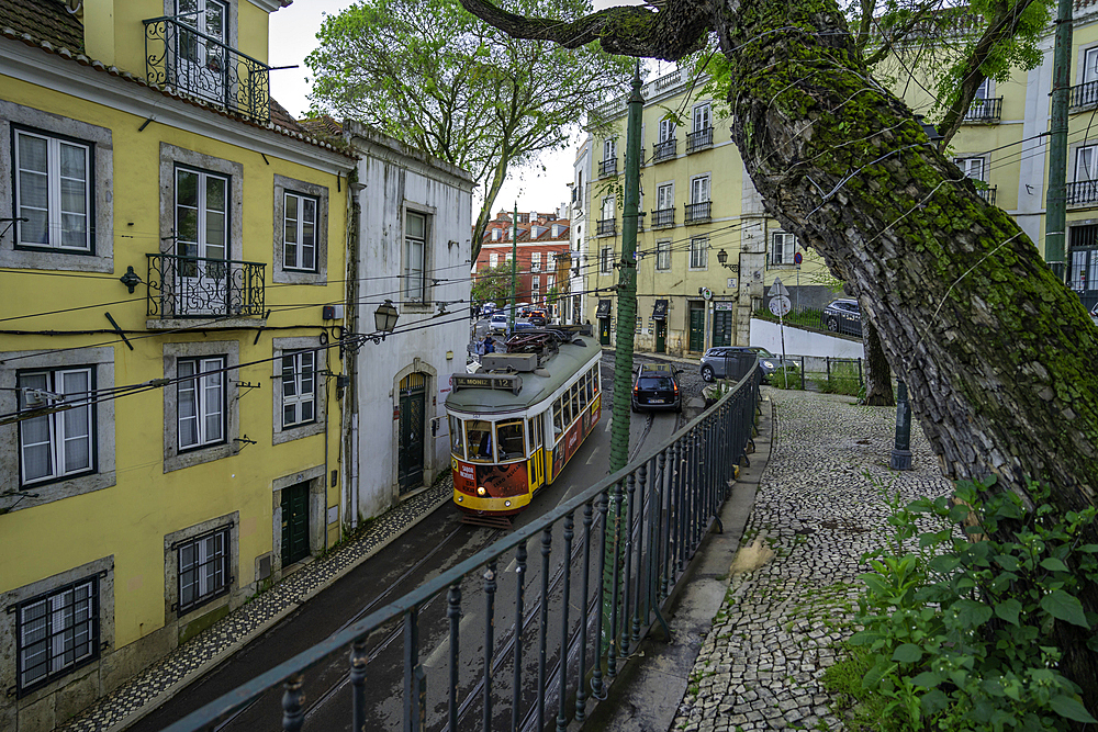 View of vintage tram and colourful buildings in the Alfama District on a sunny day, Lisbon, Portugal, Europe