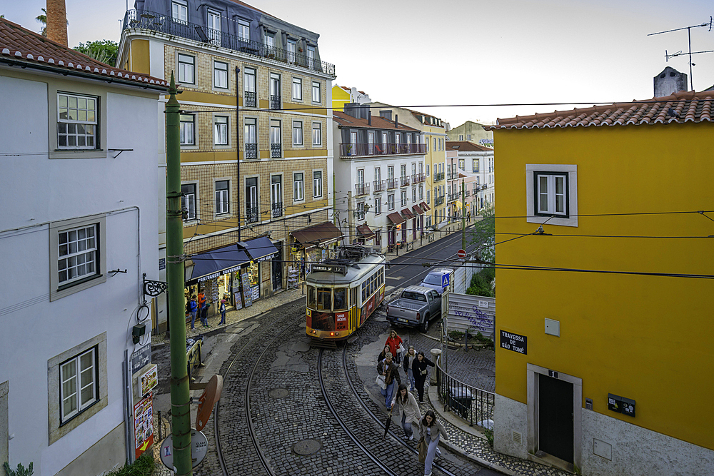 View of vintage tram and colourful buildings in the Alfama District on a sunny day, Lisbon, Portugal, Europe