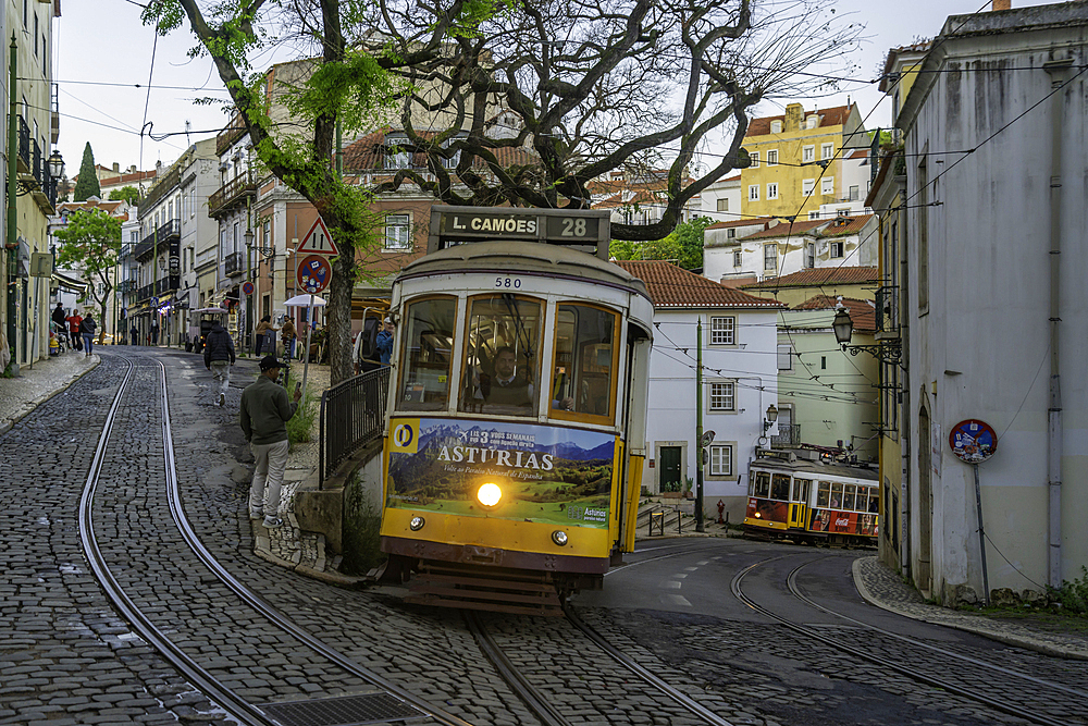 View of vintage tram and colourful buildings in the Alfama District on a sunny day, Lisbon, Portugal, Europe