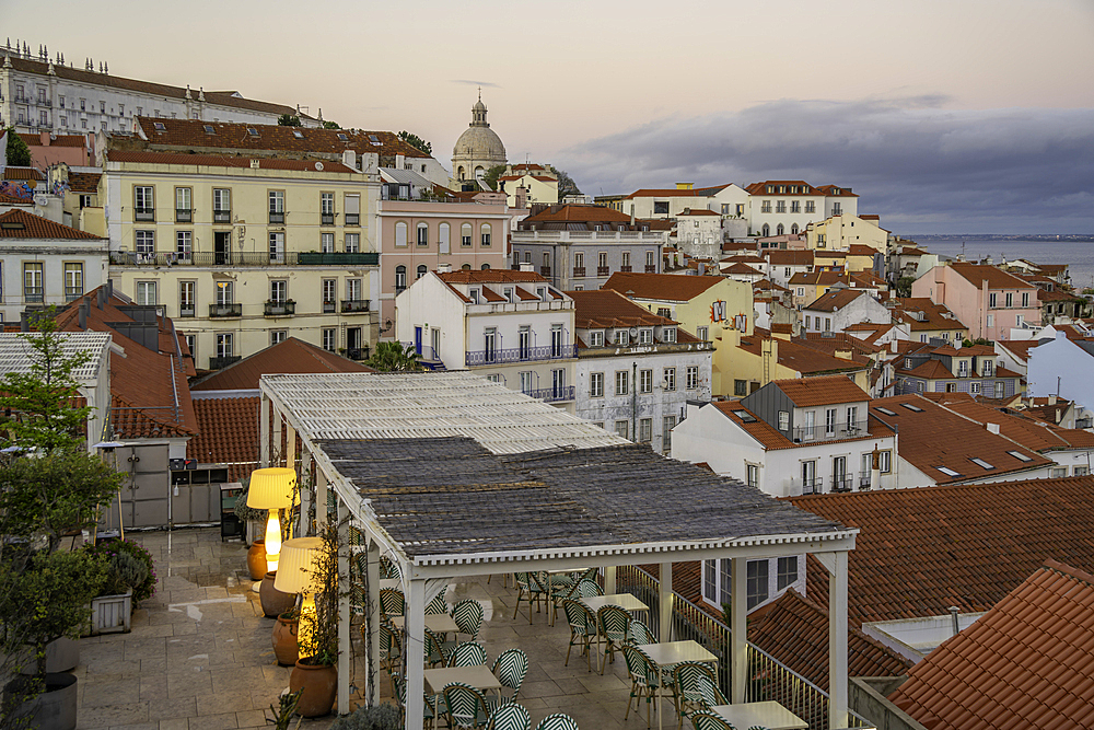 View of colourful buildings and red rooftops at sunset in the Alfama District, Lisbon, Portugal, Europe