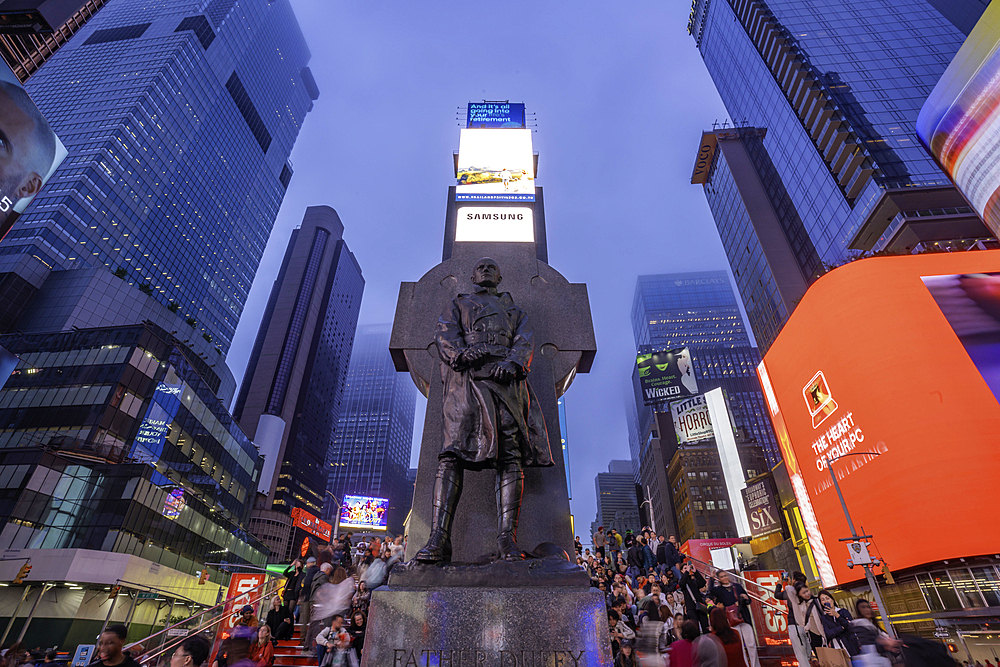 View of neon lights in Times Square at dusk, New York City, United States of America, North America