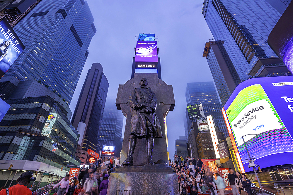 View of neon lights in Times Square at dusk, New York City, United States of America, North America