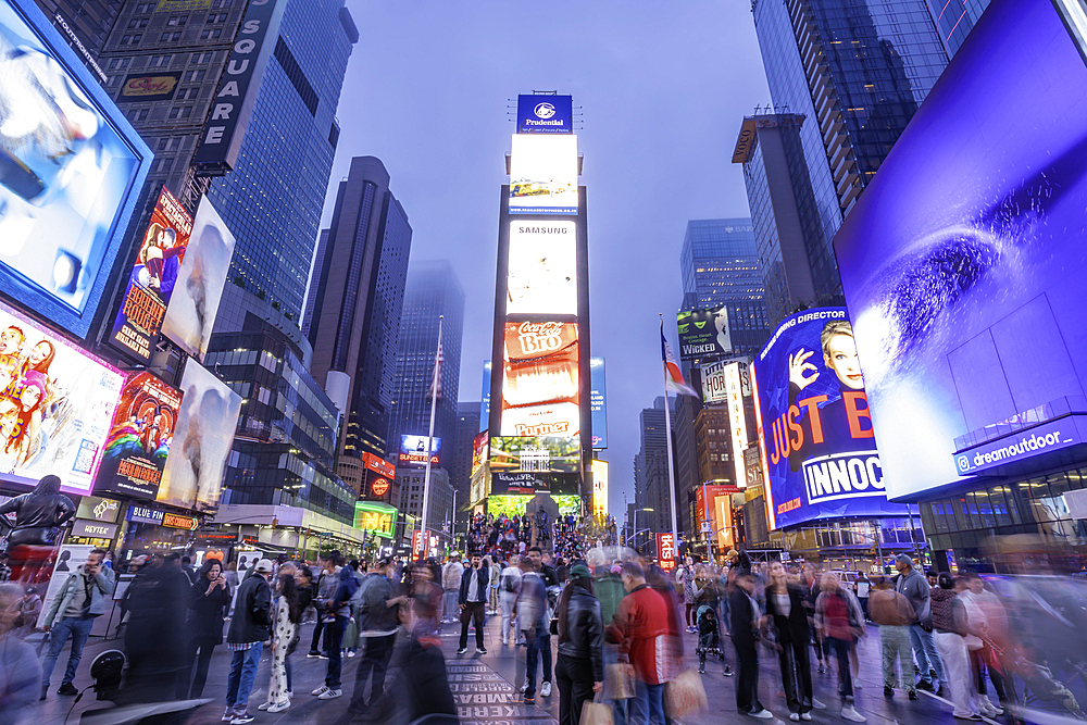 View of neon lights in Times Square at dusk, New York City, United States of America, North America