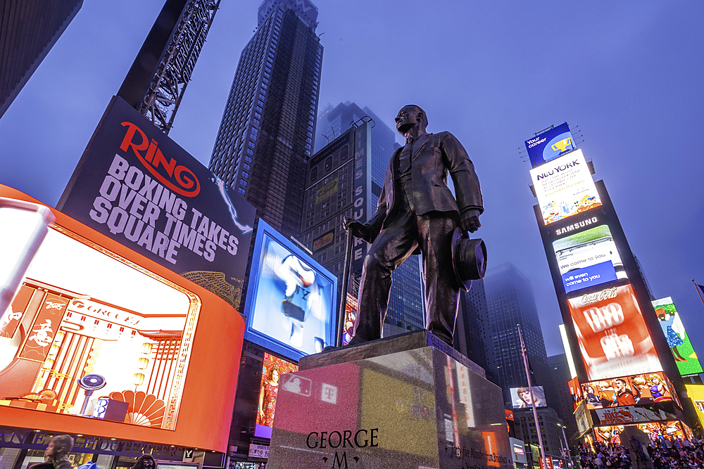 View of neon lights in Times Square at dusk, New York City, United States of America, North America
