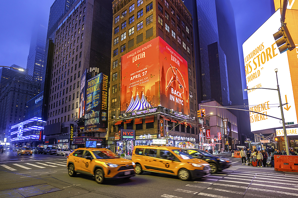 View of neon lights in Times Square at dusk, New York City, United States of America, North America