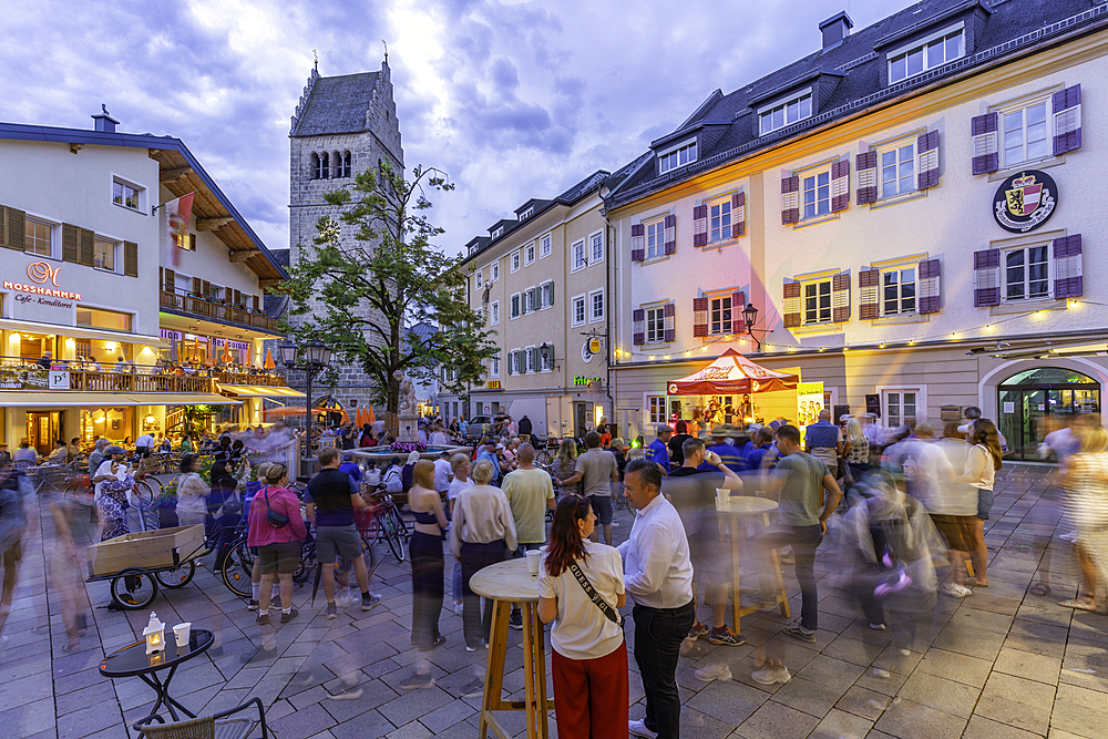 View of St. Hippolyte Church and cafe in Stadtplatz in Zell am See at dusk, Zell am See, Salzburg, Austria, Europe