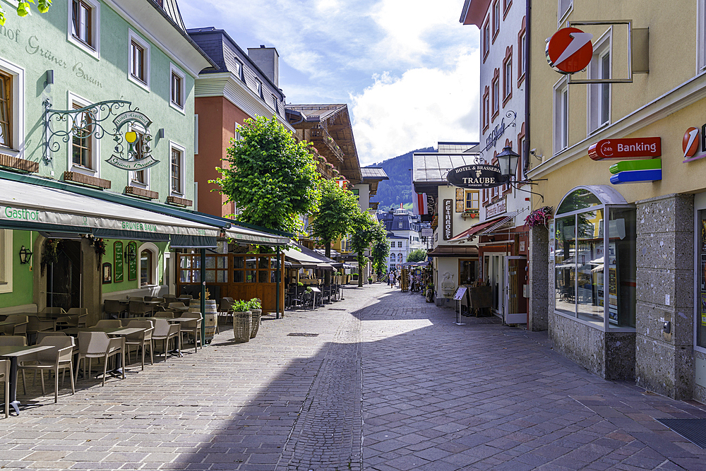 View of restaurants and cafes and street scene in Zell am See on a sunny day, Zell am See, Salzburg, Austria, Europe