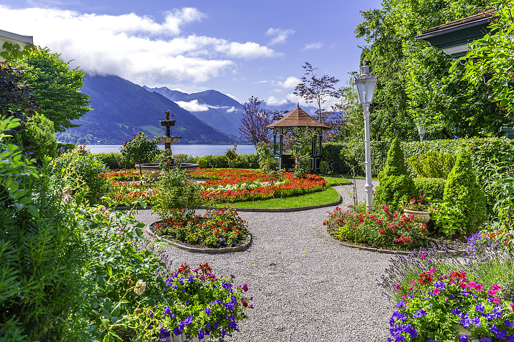 View of garden overlooking Lake Zell in Zell am See on a sunny day, Zell am See, Salzburg, Austria, Europe