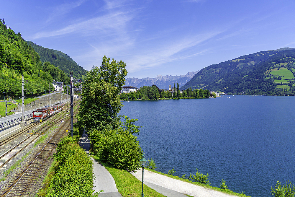 View of train to Zell am See and Lake Zell on a sunny day, Zell am See, Salzburg, Austria, Europe