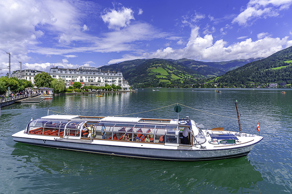 View of the Grand Hotel, tour boat and Lake Zell in Zell am See on a sunny day, Zell am See, Salzburg, Austria, Europe