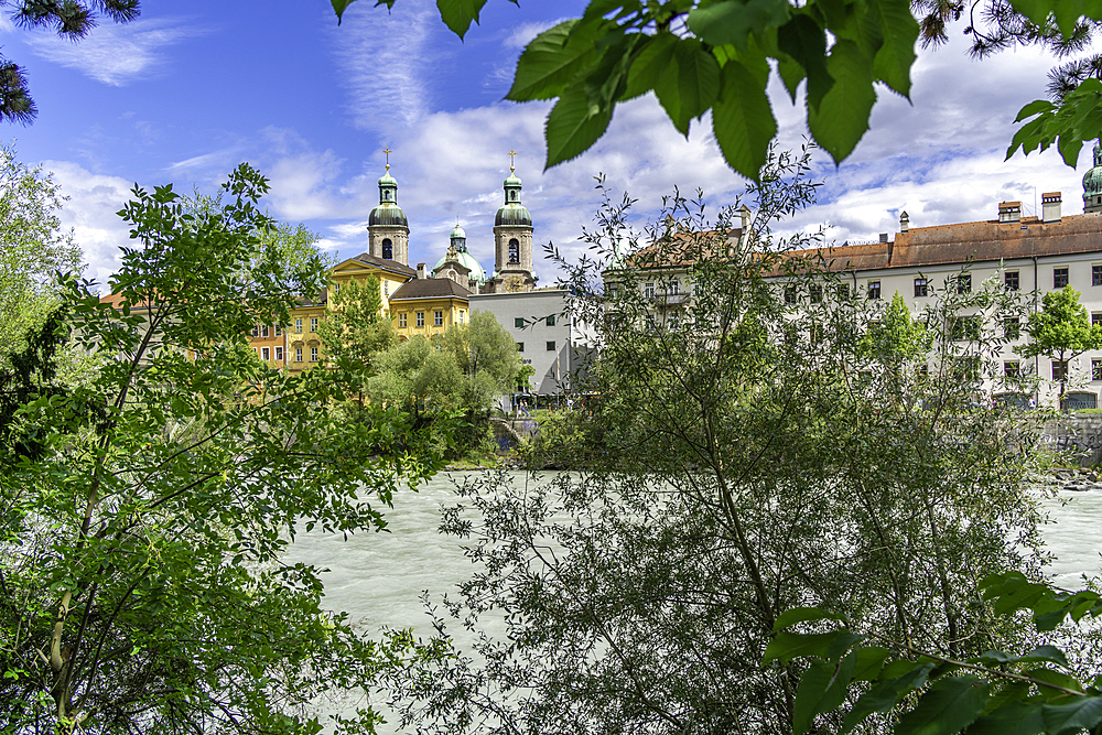 View of St. Jakob Cathedral, colourful buildings and River Inn on a sunny day in summer, Innsbruck, Tyrol Region, Austria, Europe