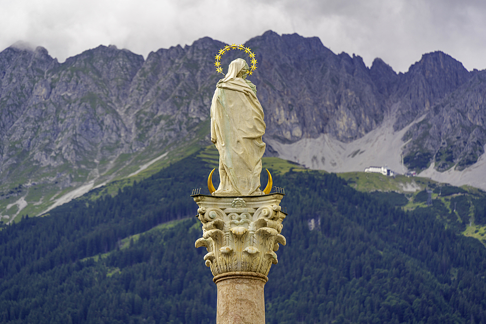View of Virgin Mary on Annasäule in the old town with mountainous backdrop in summer, Innsbruck, Tyrol Region, Austria, Europe