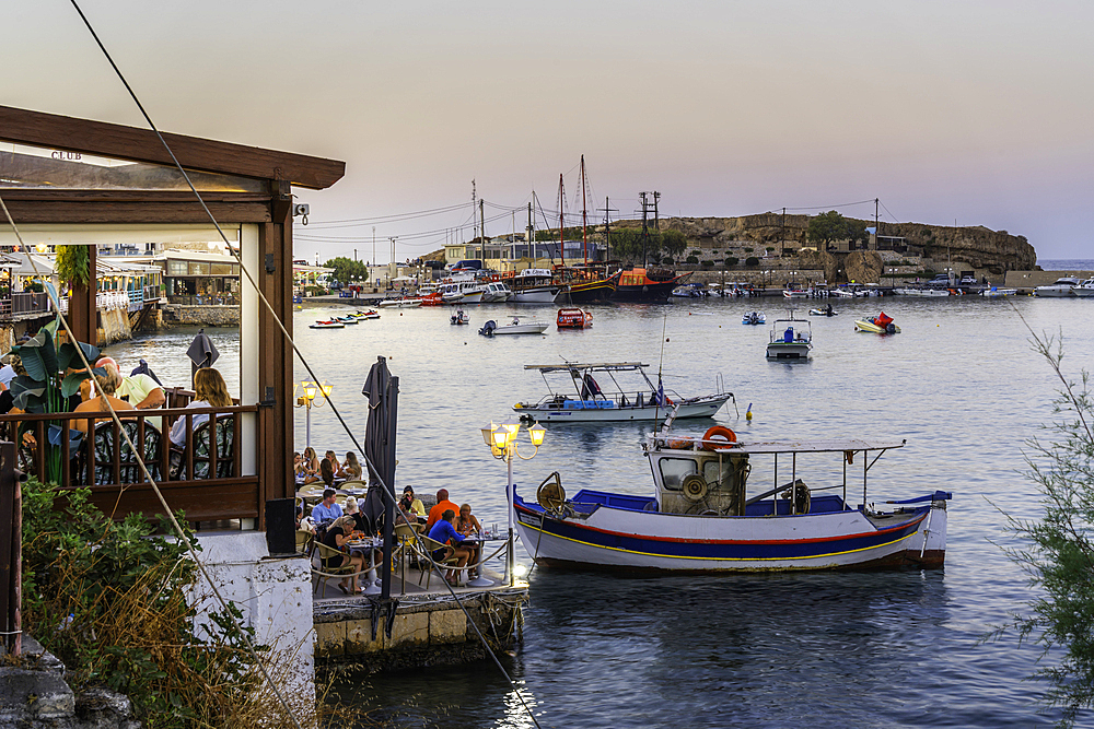 View of taverna and Port of Limenas Chersonisou at dusk, Limenas Chersonisou, Crete, Greek Islands, Greece, Europe