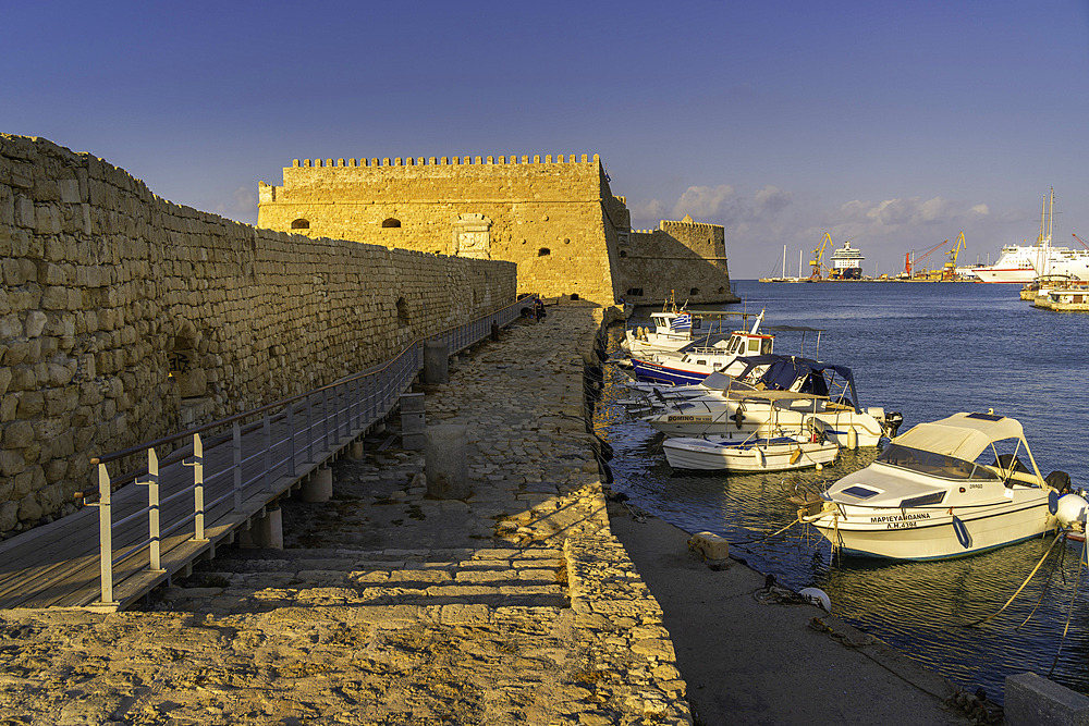 View of Koules Venetian Fortress and boats in Heraklion Venetian Port at sunset, City of Heraklion, Crete, Greek Islands, Geece, Europe