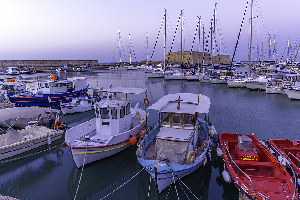View of Koules Venetian Fortress and boats in Heraklion Venetian Port at dusk, City of Heraklion, Crete, Greek Islands, Geece, Europe