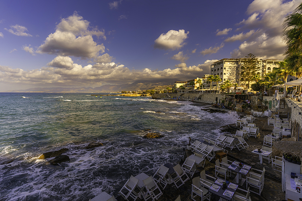 View of taverna overlooking the sea in Limenas Chersonisou at sunset, Crete, Greek Islands, Greece, Europe
