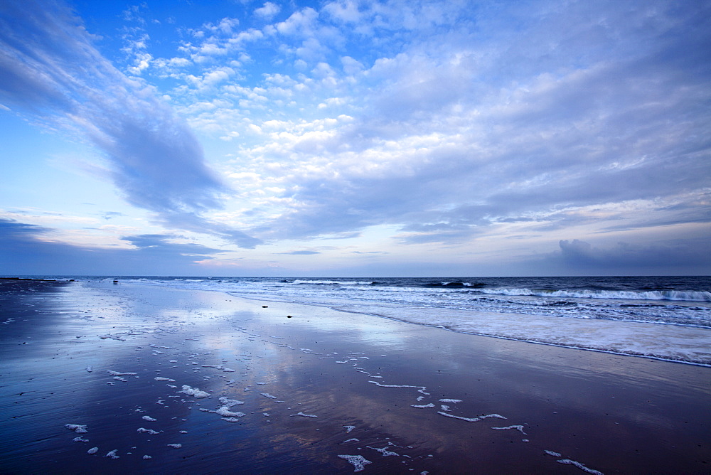 Cloud reflections at twilight on Alnmouth Beach, Northumberland, England, United Kingdom, Europe