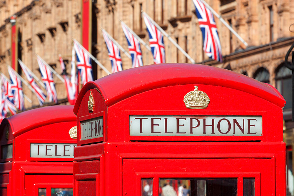 Red telephone boxes opposite Harrod's, Knightsbridge, London, England, United Kingdom, Europe