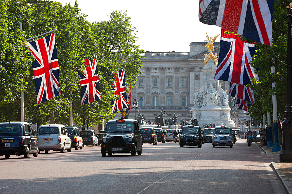 Buckingham Palace with taxis and Union Jacks along The Mall, London, England, United Kingdom, Europe