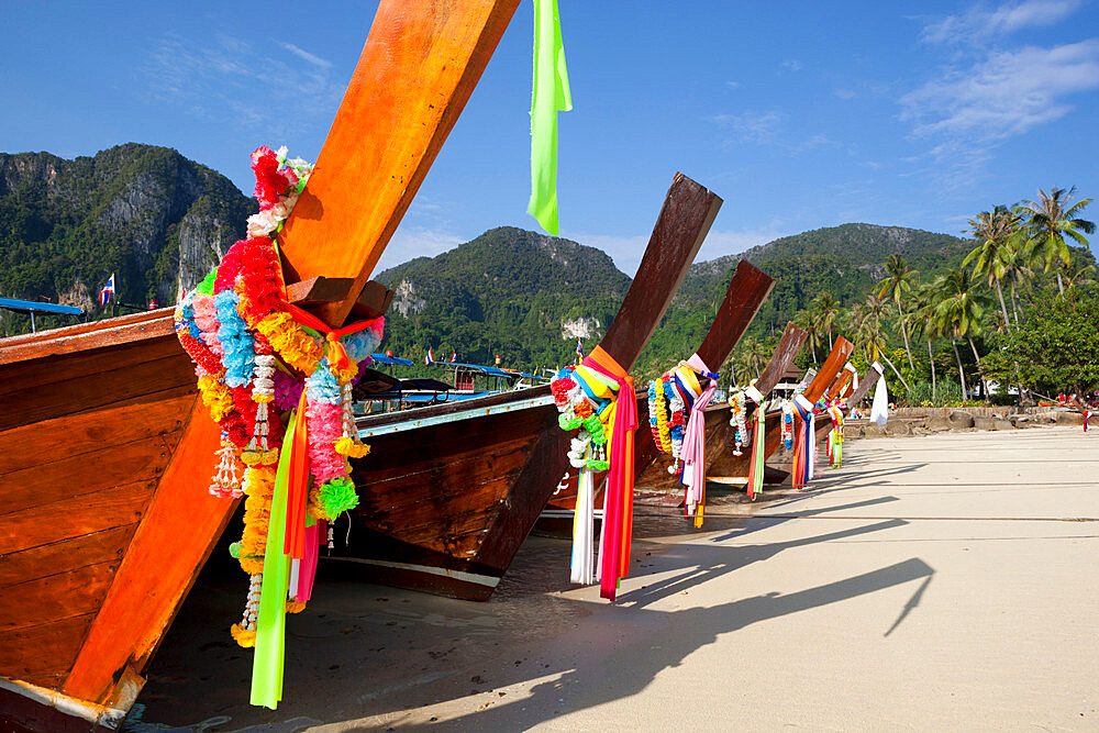 Garlands decorating long-tail boats on beach, Koh Phi Phi, Krabi Province, Thailand, Southeast Asia