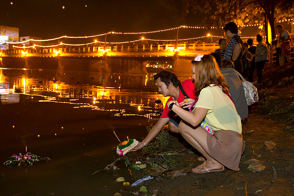 Releasing offerings into river at Loi Krathong festival, Chiang Mai, Northern Thailand, Thailand, Southeast Asia, Asia