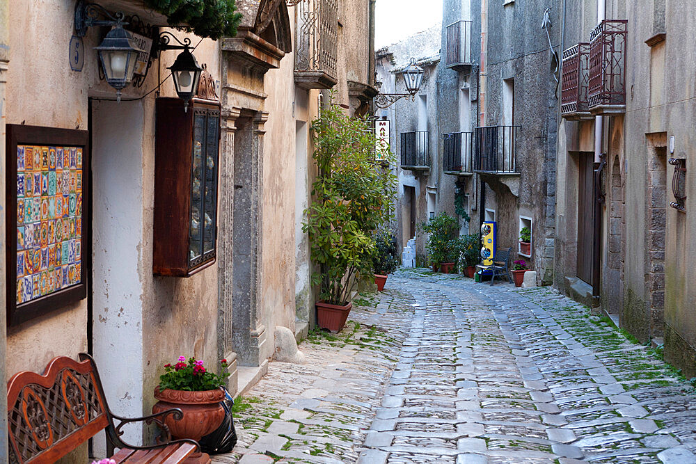 View down narrow cobbled street, Erice, Sicily, Italy, Europe