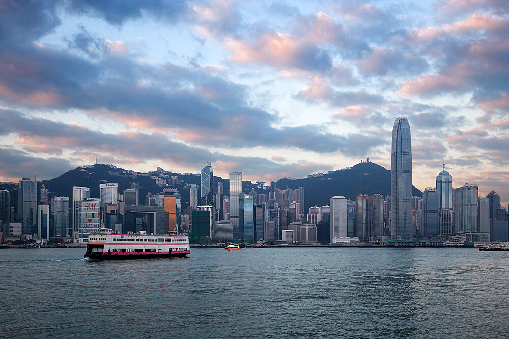 View over Victoria harbour to Hong Kong Island and The Peak at dusk, Hong Kong, China, Asia