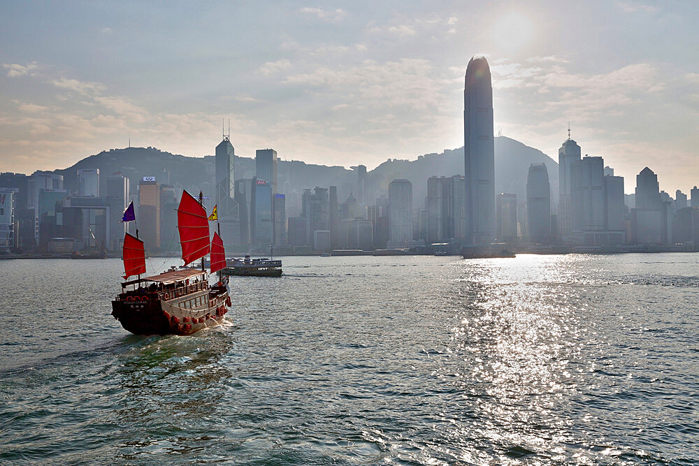 Aqua Luna Junk boat in Victoria harbour with Hong Kong skyline, Hong Kong, China, Asia