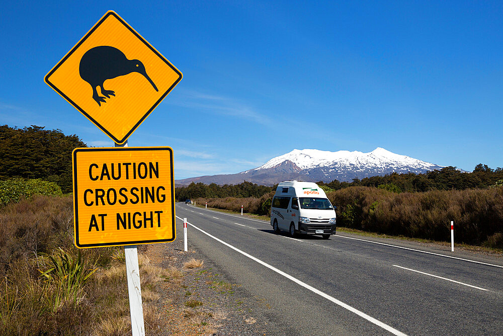 Motorhome below Mount Ruapehu with Kiwi crossing sign, Tongariro National Park, UNESCO World Heritage Site, North Island, New Zealand, Pacific