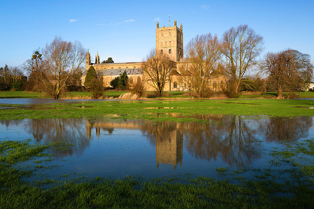 Tewkesbury Abbey reflected in flooded meadow, Tewkesbury, Gloucestershire, England, United Kingdom, Europe