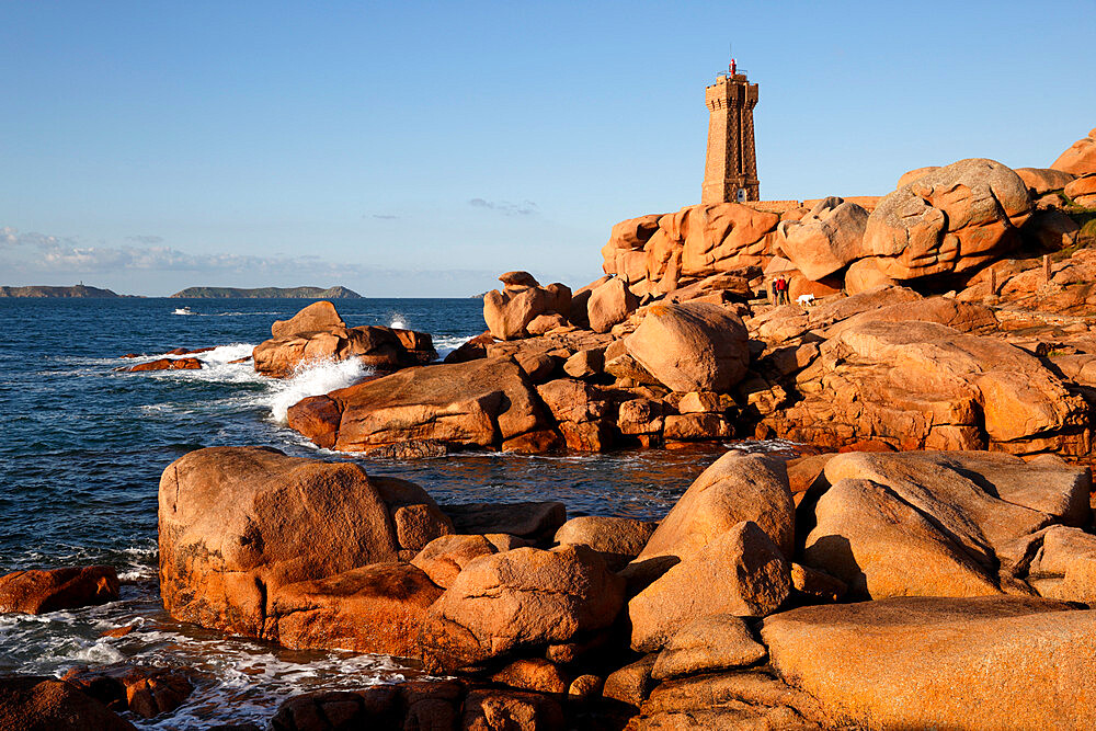 Lighthouse and pink rocks at sunset, Ploumanach, Cote de Granit Rose, Cotes d'Armor, Brittany, France, Europe