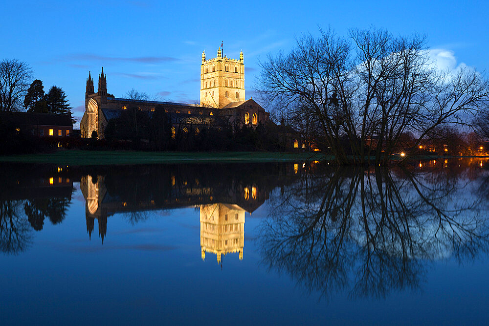 Tewkesbury Abbey reflected in water at dusk, Tewkesbury, Gloucestershire, England, United Kingdom, Europe