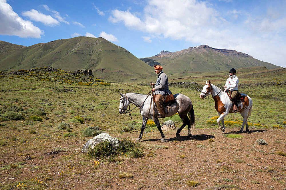 Gaucho guide and tourist on horse at Estancia Alta Vista, El Calafate, Parque Nacional Los Glaciares, UNESCO World Heritage Site, Patagonia, Argentina, South America