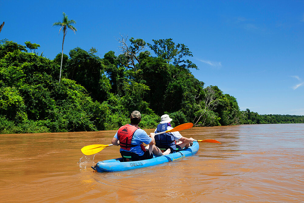 Kayaking on the Iguazu River past sub-tropical rainforest, near Andresito, Iguazu National Park, Misiones Province, Argentina, South America