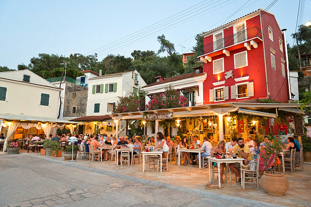 Harbourside restaurants in evening, Loggos, Paxos, Ionian Islands, Greek Islands, Greece, Europe