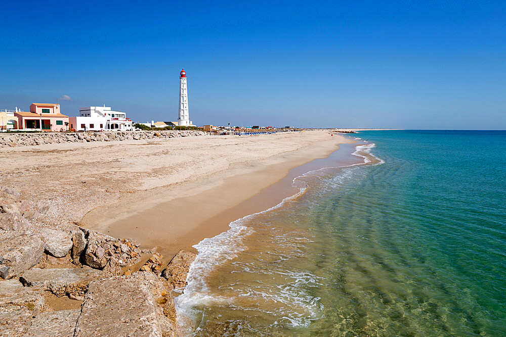 Lighthouse and beach of Ilha do Farol, Culatra barrier island, Olhao, Algarve, Portugal, Europe