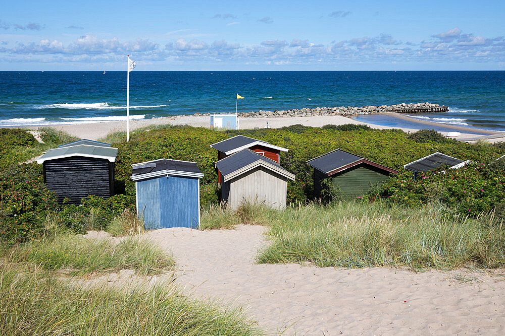 Beach huts among sand dunes with blue sea behind, Tisvilde, Kattegat Coast, Zealand, Denmark, Scandinavia, Europe