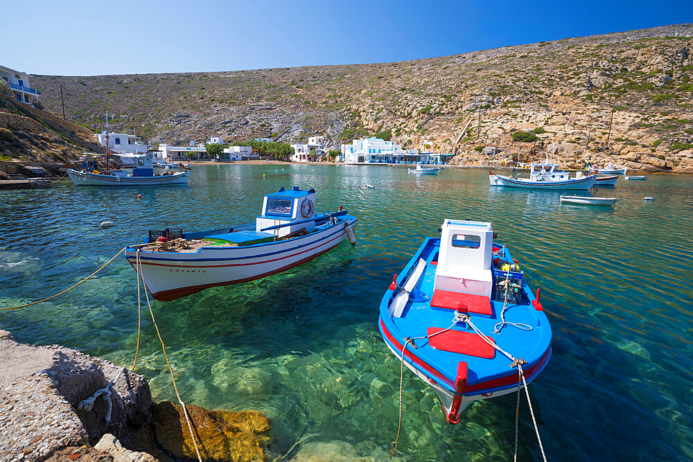 View over crystal clear water and fishing boats in harbour, Cheronissos, Sifnos, Cyclades, Aegean Sea, Greek Islands, Greece, Europe