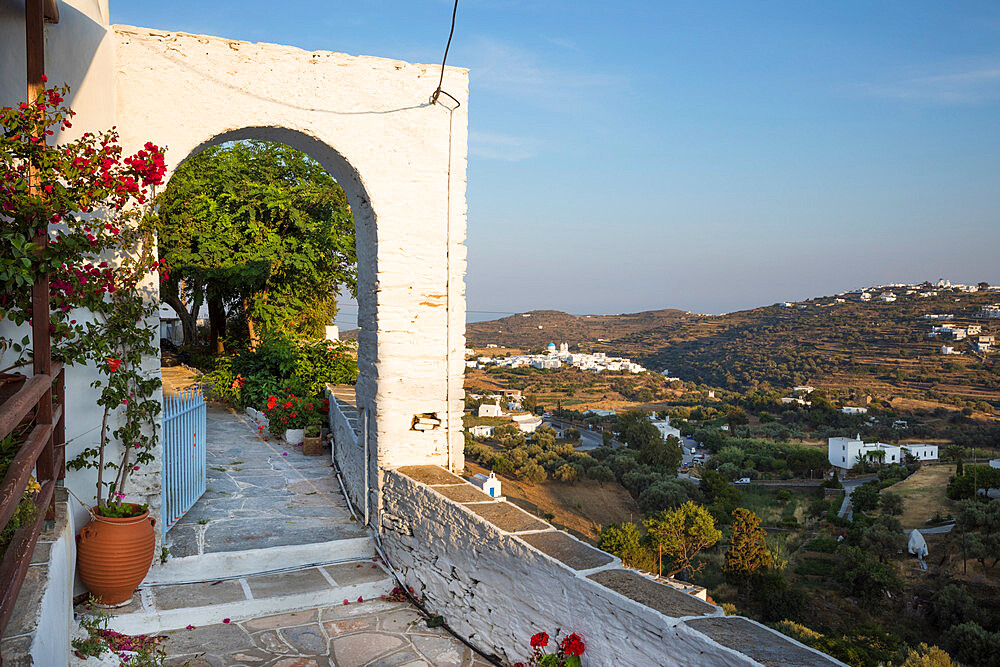 Arched entrance to courtyard garden with views over island, Apollonia, Sifnos, Cyclades, Aegean Sea, Greek Islands, Greece, Europe