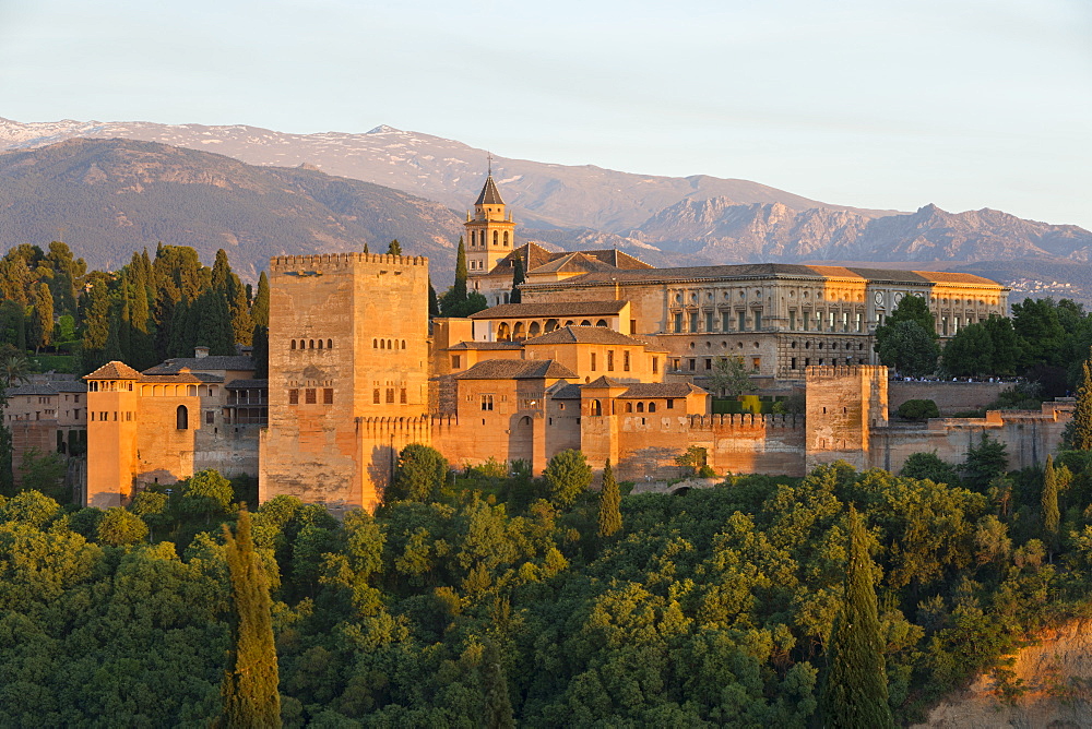 The Alhambra, UNESCO World Heritage Site, and Sierra Nevada mountains in evening light from Mirador de San Nicolas, Granada, Andalucia, Spain, Europe