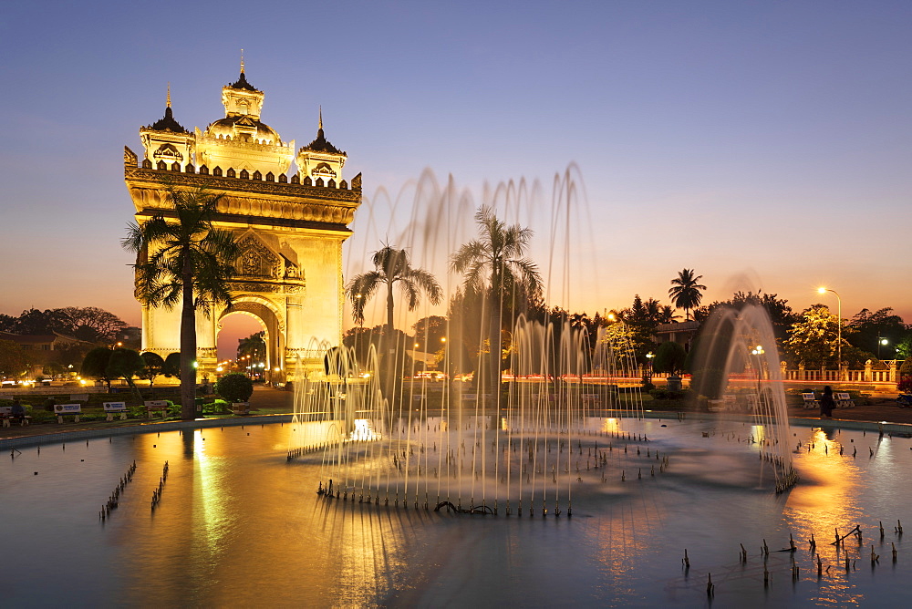 Patuxai Victory Monument (Vientiane Arc de Triomphe) and fountain floodlit at dusk, Vientiane, Laos, Indochina, Southeast Asia, Asia