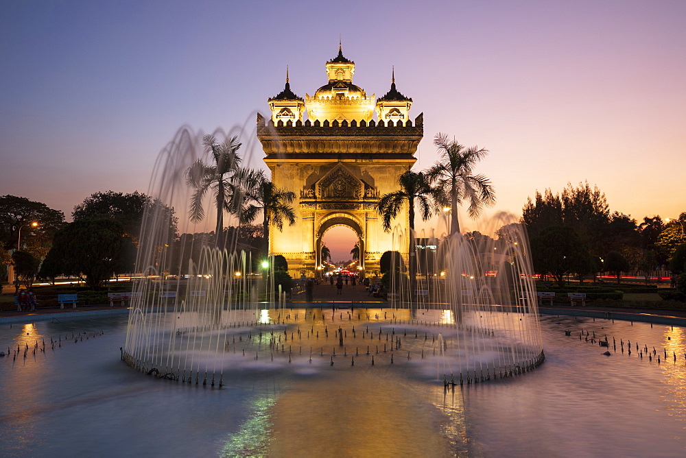 Patuxai Victory Monument (Vientiane Arc de Triomphe) and fountain floodlit at dusk, Vientiane, Laos, Indochina, Southeast Asia, Asia