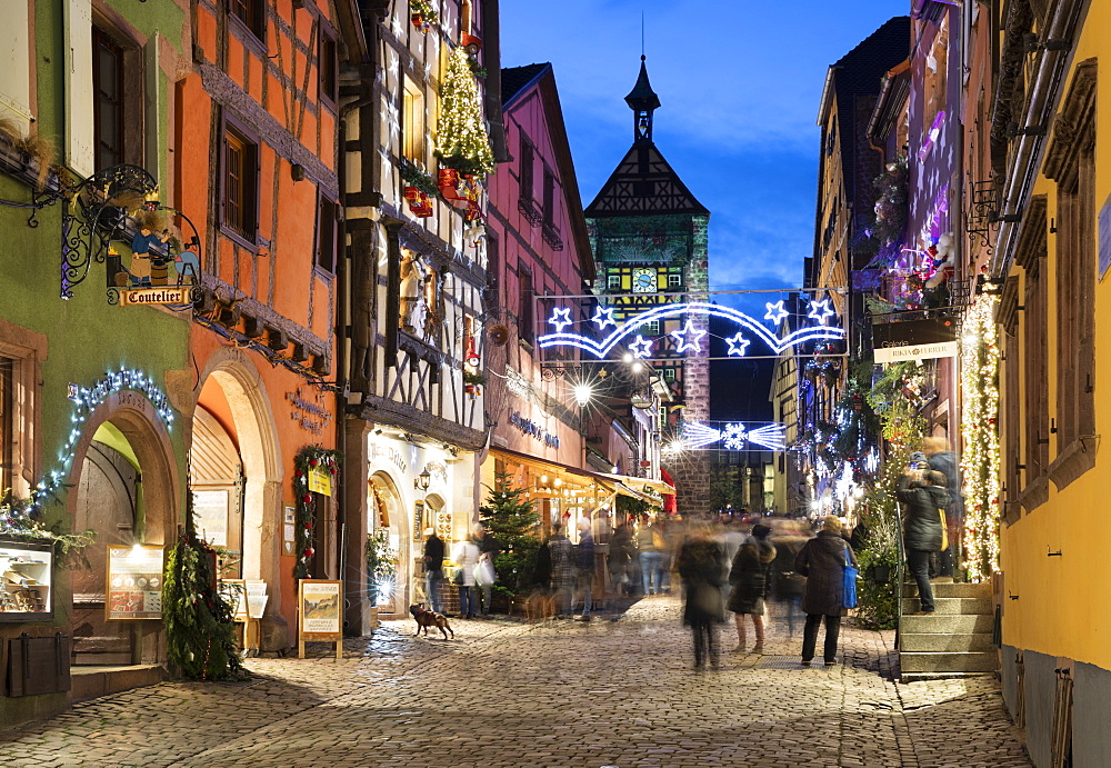 Rue du General de Gaulle covered in Christmas decorations illuminated at night, Riquewihr, Alsace, France, Europe